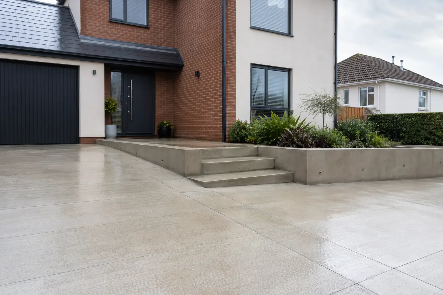 Freshly cleaned concrete driveway steps and retaining wall