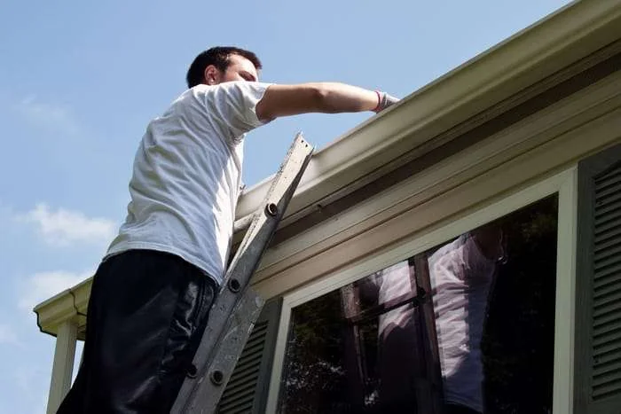 Clearing a blocked gutter at a Cardiff property